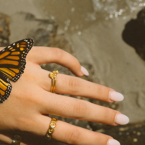 Petals ring in 24ct gold plate — worn beside a monarch butterfly and gold band
