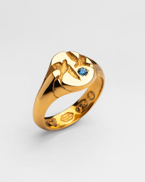 Loyal Signet in 24ct gold plate — angled view of two swallows and blue topaz