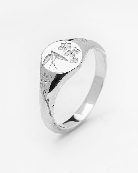 Return Signet in sterling silver — angled product view showing swallow and floral engraving