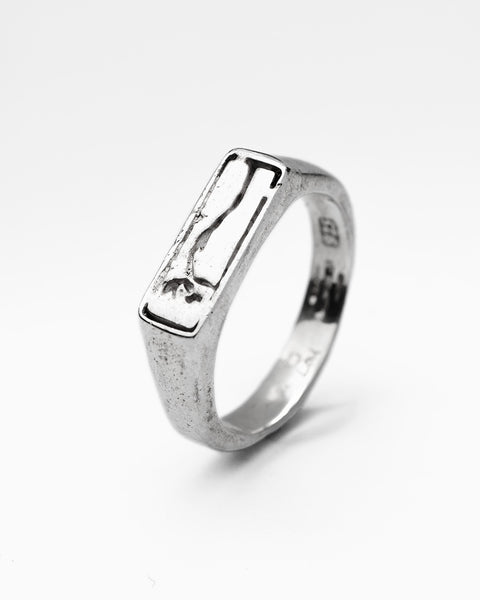 Bloom Signet in sterling silver — angled product view showing the flower stem engraving