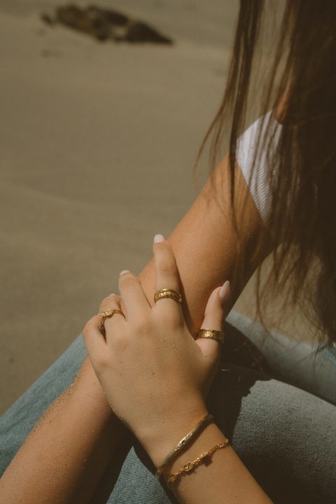 Serene Pair in 24ct gold plate — worn together with mixed gold jewellery in sunlight