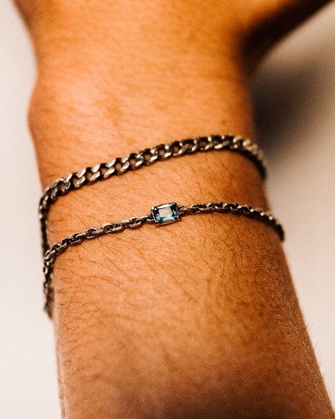 Lou's Cuban in sterling silver — close-up worn above a fine bracelet with a blue stone