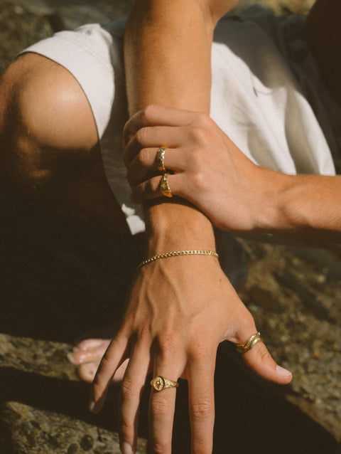 Serene I ring in 24ct gold plate — worn among mixed gold rings outdoors