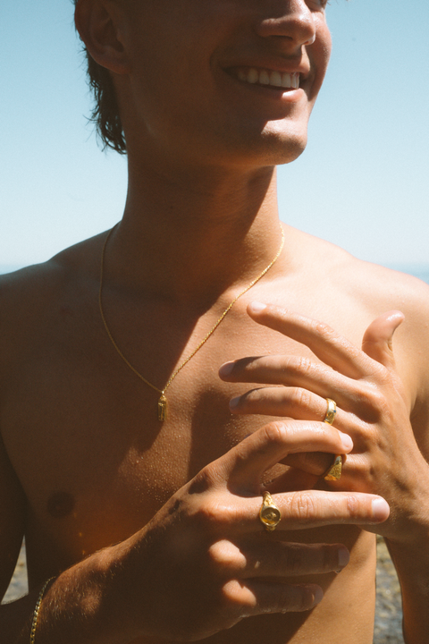 Coalesce ring in 24ct gold plate — worn with other gold rings in sunlight