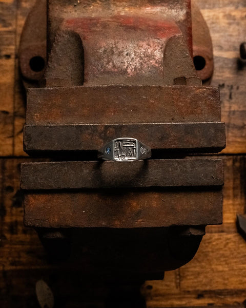 Workshop Signet in sterling silver — displayed on a workshop bench vise