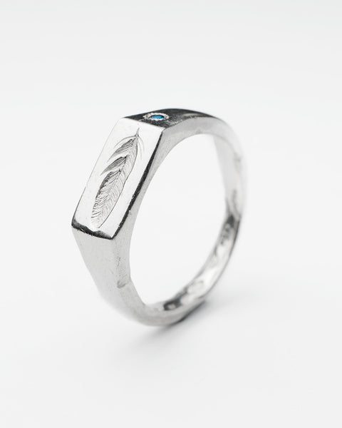 Feather Signet in sterling silver — angled view of the engraved feather and blue topaz