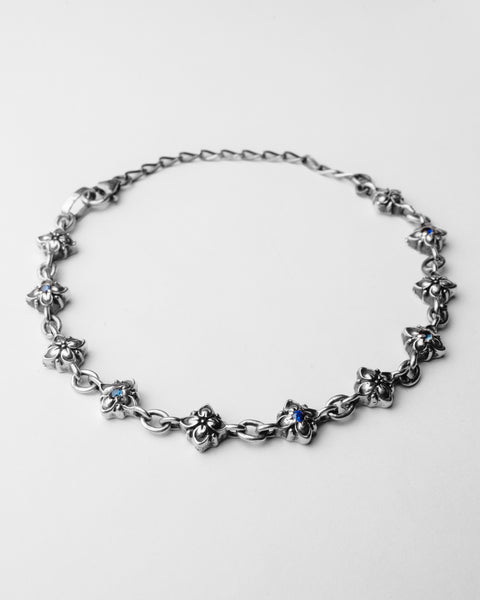 Signature Bracelet in sterling silver — full laid-flat view of linked flowers with blue stones