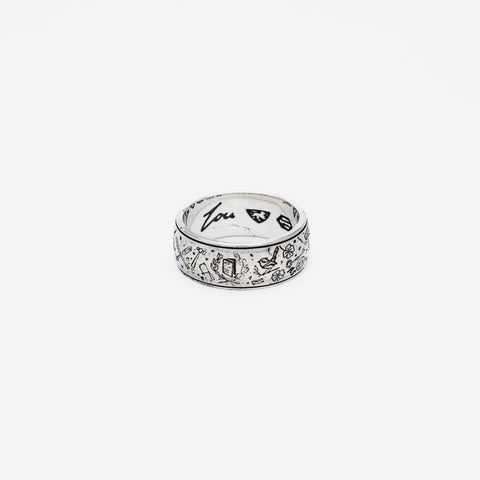 The Grad Ring in sterling silver — front view with the inner Lou signature visible