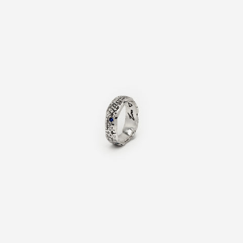 Lou's Grad Ring in sterling silver — small angled product view with one blue gemstone visible