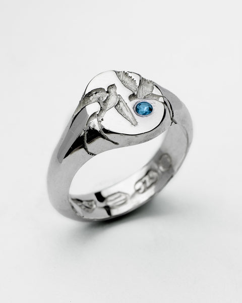Loyal Signet in sterling silver — angled front showing swallow engraving and blue stone