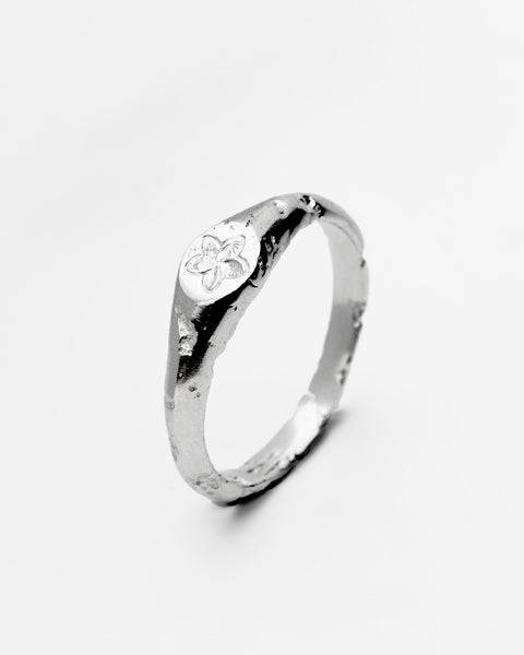 Plumeria ring in sterling silver — angled view of the frangipani motif and organic band