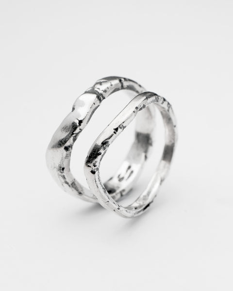 Serene Pair in sterling silver — angled view of the slim and wide organic bands together