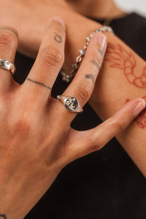 Return Signet in sterling silver — worn on hand with the engraved face visible