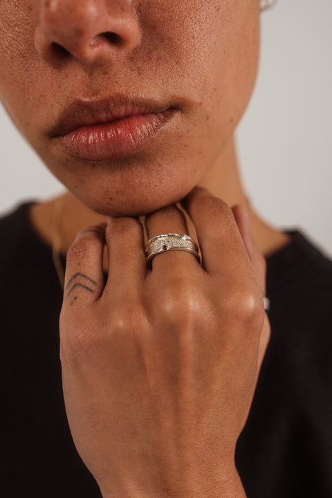 Vivid ring in sterling silver — worn near the face with the ruby and zirconia visible