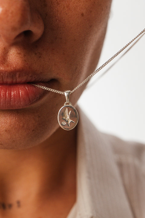 Family Pendant in sterling silver — close-up worn near the face