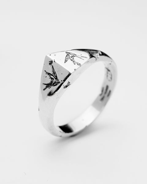 Swallows ring in sterling silver — angled view showing two engraved swallows