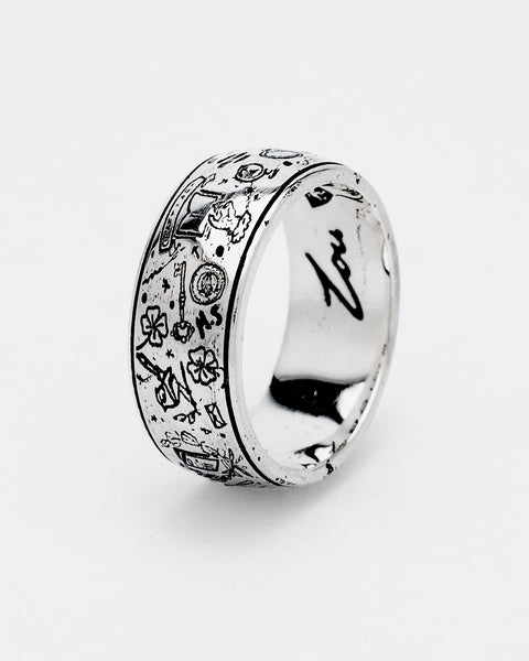 The Grad Ring in sterling silver — angled view of the wide engraved band