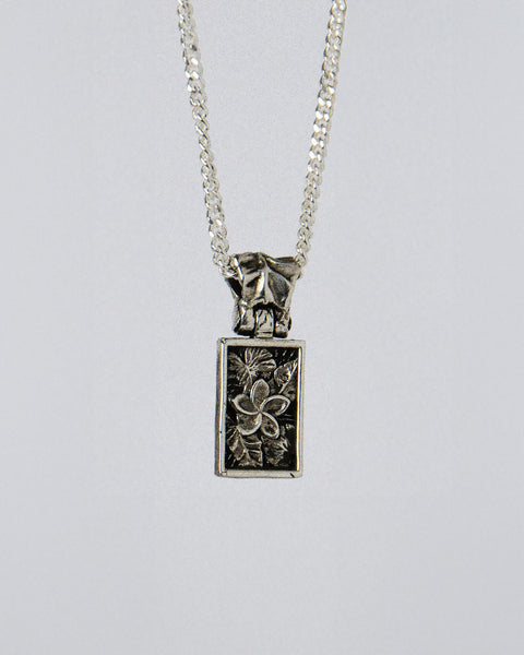 Nascence Pendant in sterling silver — front view of the frangipani engraving on chain